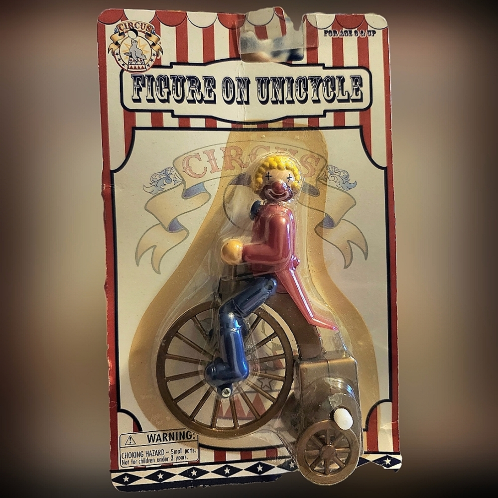 Figure on Unicycle Toy - Red, Blue, Yellow